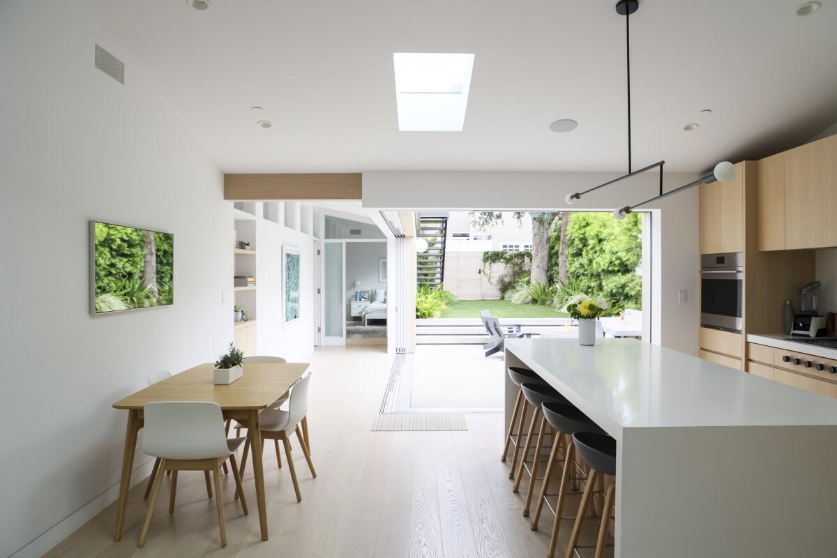 An open kitchen that opens on to a courtyard, lawn and ADU