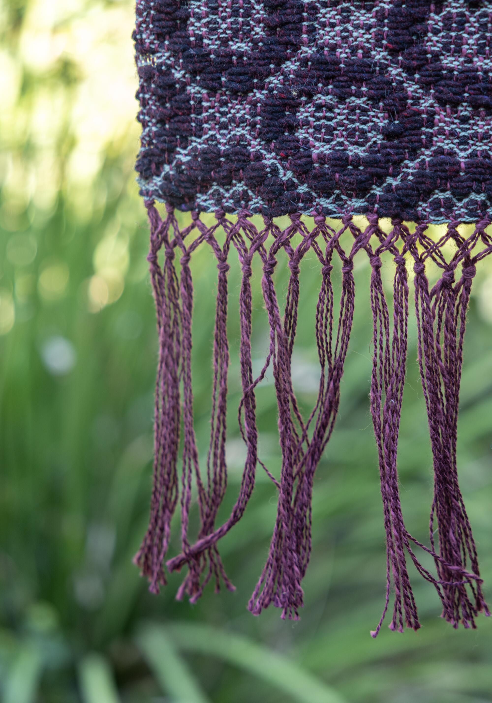 Close-up of a purple and blue weaving.