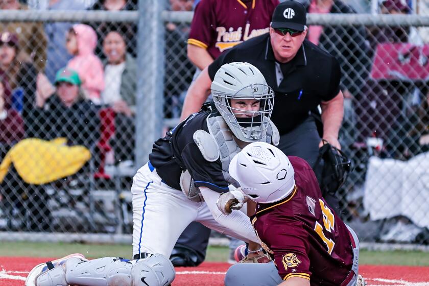 El Camino Real catcher Adan Viner tags out Point Loma's Phoenix Brant on a throw from center field in the first inning. 