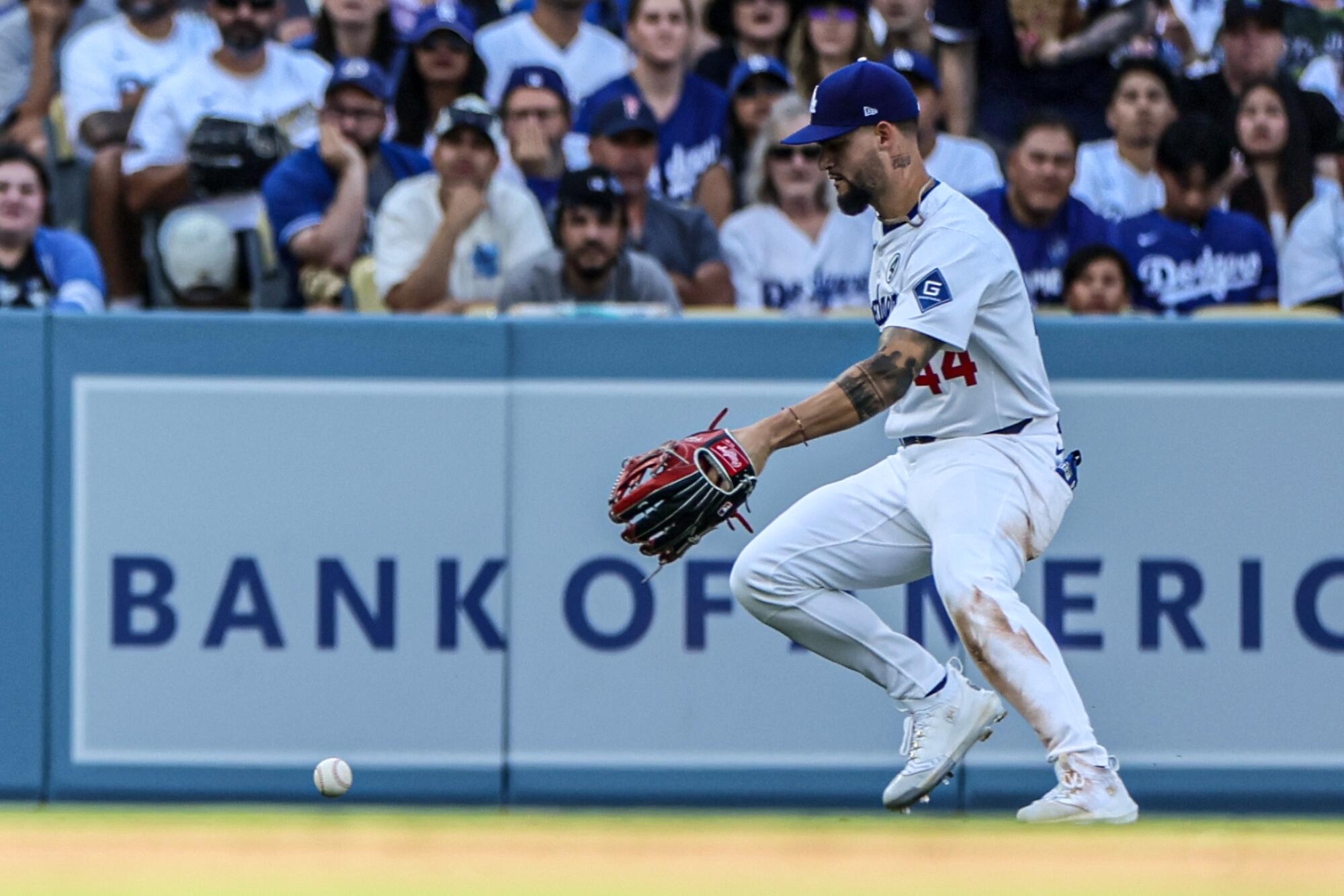 Dodgers outfielder Andy Pages bobbles a hit by New York's DJ LeMahieu at Dodger Stadium.