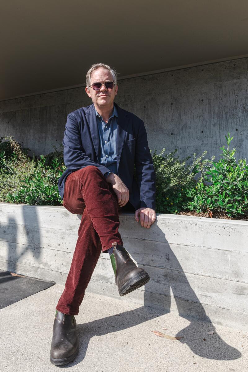 Architect Warren Techentin sits on a wall
