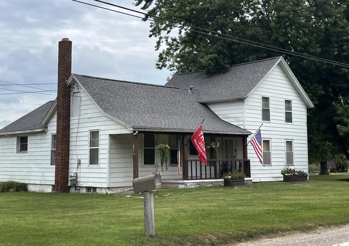 A Trump flag flies outside a home on a country road in Macomb County, Mich.