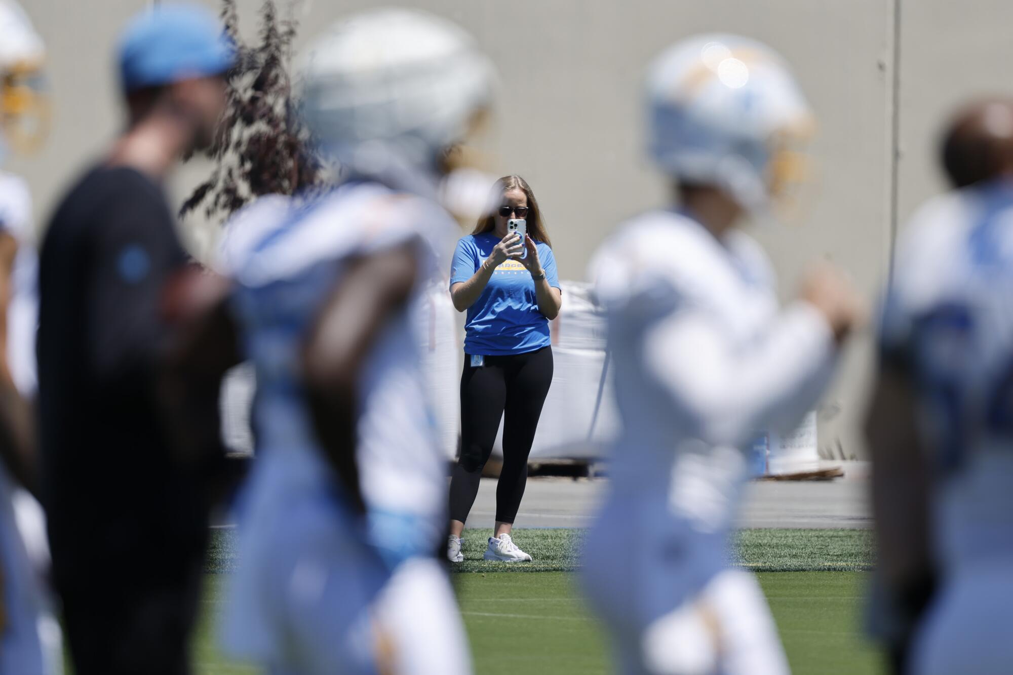 Allie Raymond records players and coaches taking part in Chargers rookie minicamp on May 9.