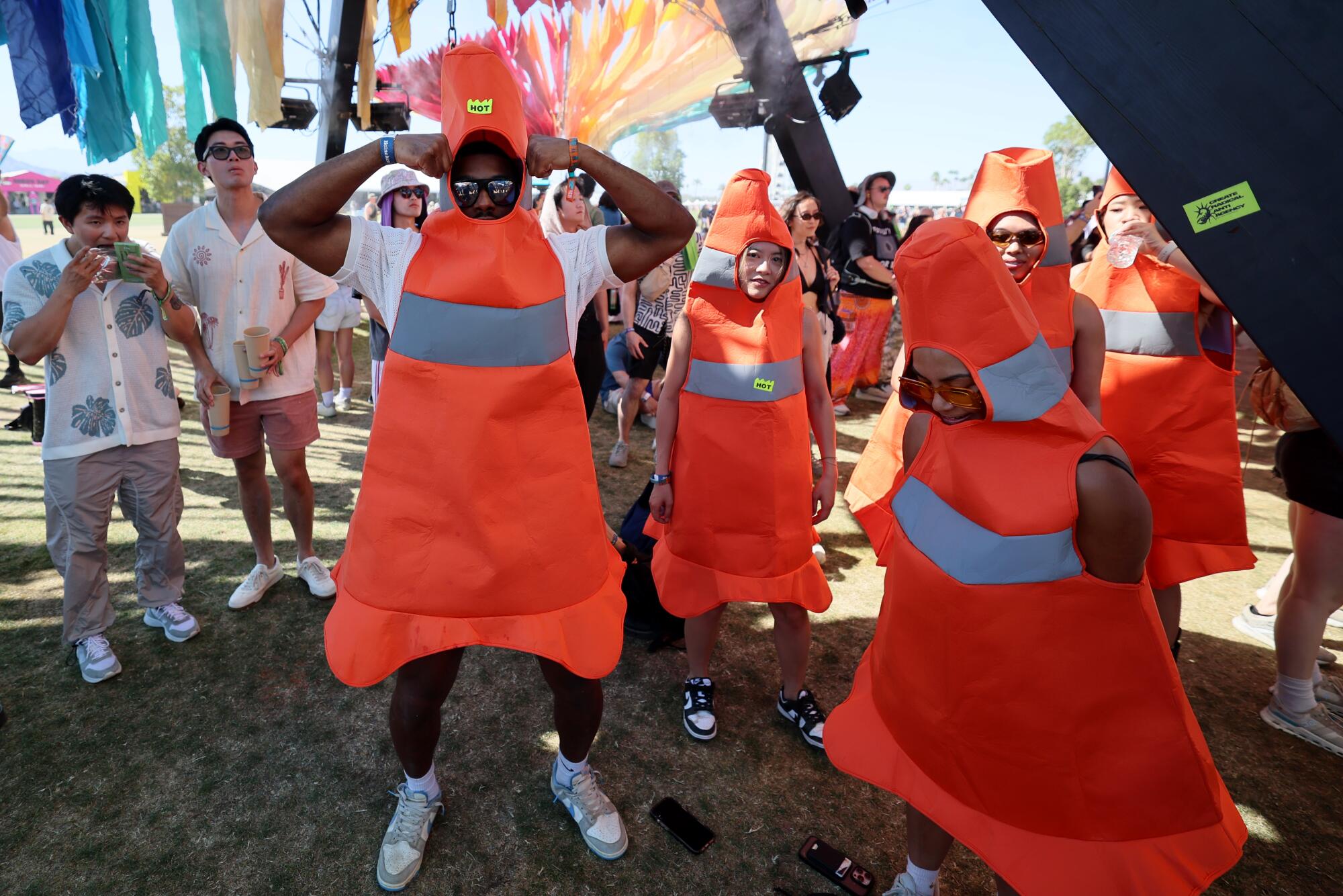 People dressed as traffic cones stop for a picture at the Do Lab.