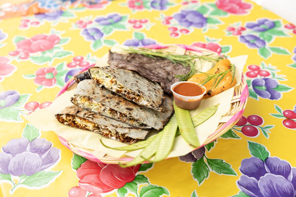 LOS ANGELES, CA - OCTOBER 25: Poncho's tlayuda with three meats - chorizo inside, asada and moronga (blood sausage) at Poncho's Tlayudas in Los Angeles, CA on Friday, Oct. 25, 2024. (Myung J. Chun / Los Angeles Times)